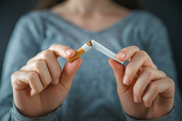 Image of a person breaking a cigarette